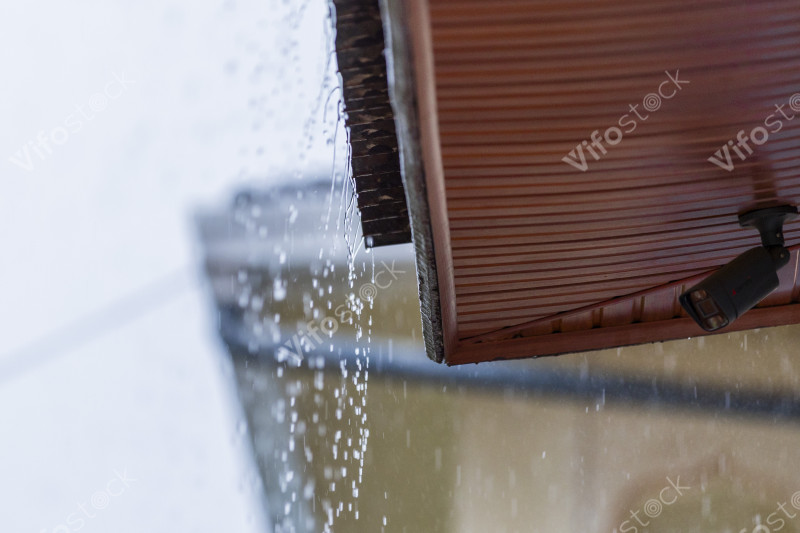 Raindrop falling from a rooftop in Kigali during a heavy downpour, 0D8A0531